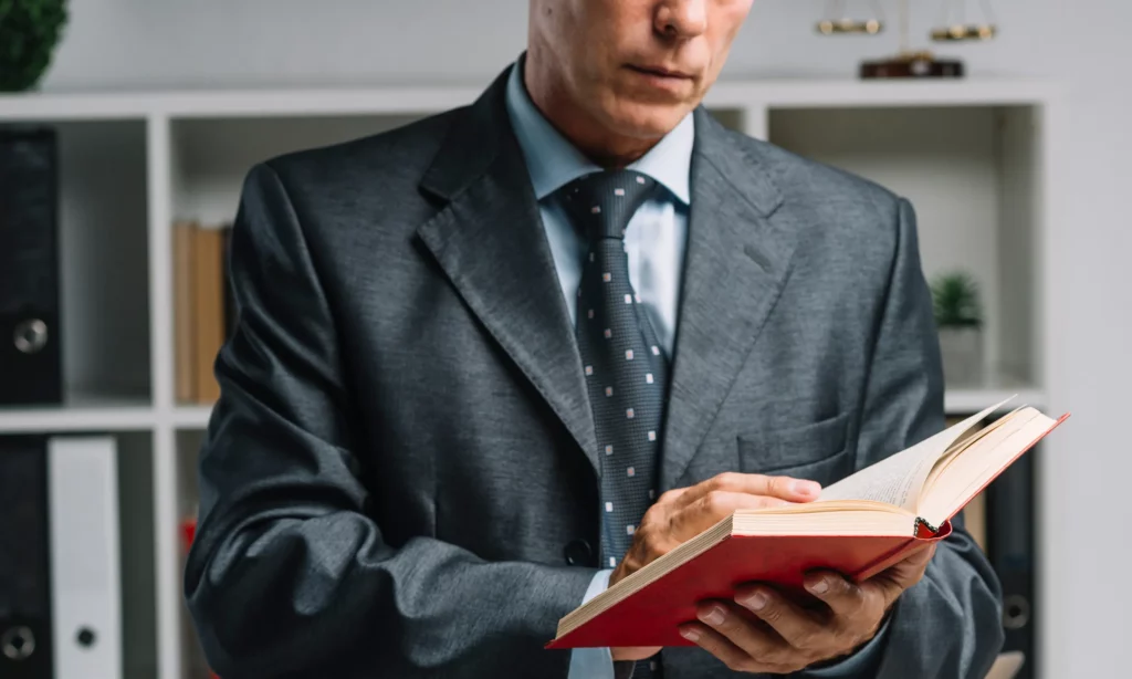 law firms benefit from LPO a male solicitor is reading a book about Australian law