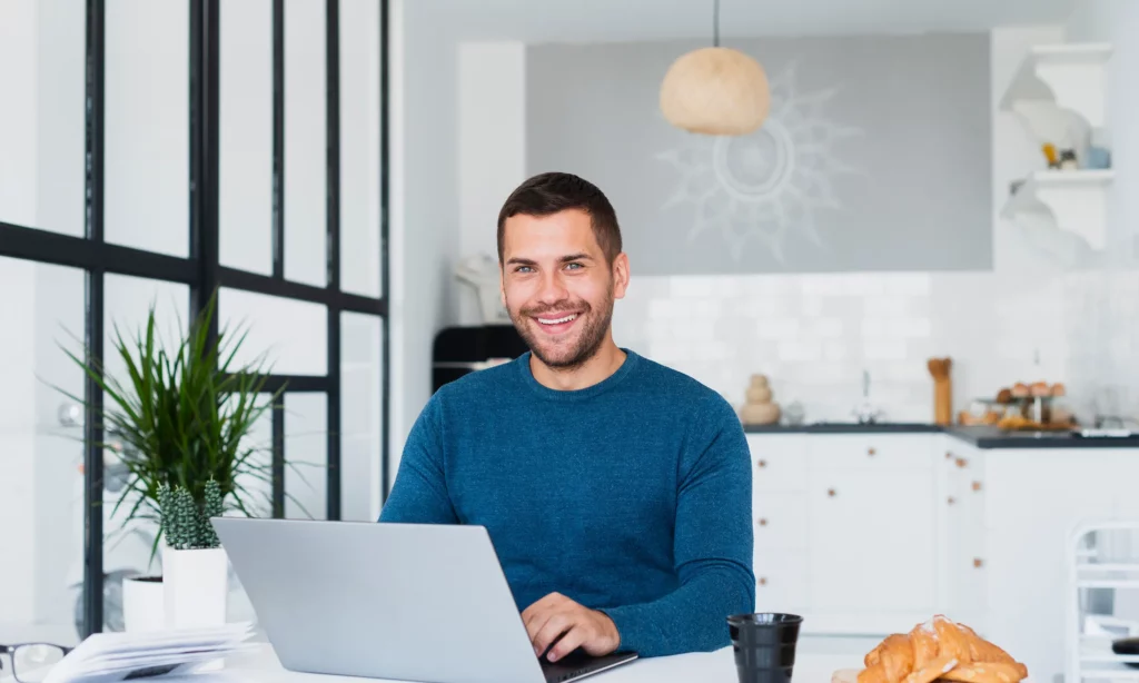 ready for permanent remote workforce a male remote staff working in the kitchen of his home